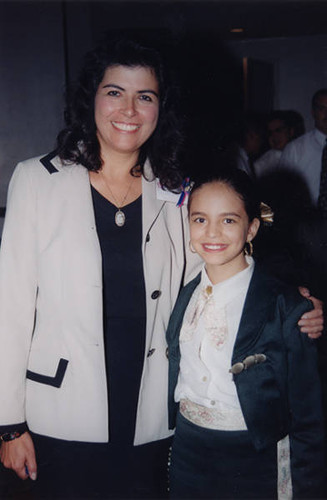 Comisión Femenil member with ten-year old singer at the 6th Adelante Mujer Latina Conference