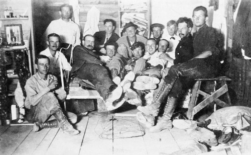 Railroad construction workers seated in tent