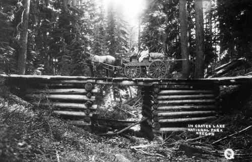 Horse and wagon crossing a log bridge