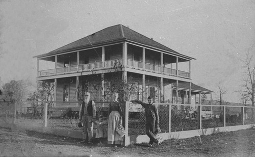 The Longs posed in front of their house