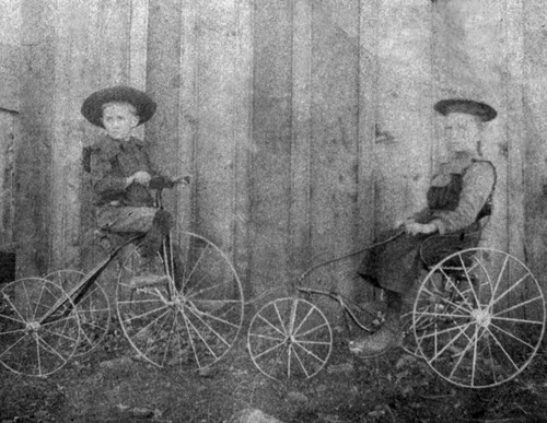 Emma Jones and another child on tricycles