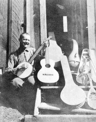 Railroad construction worker (presumably) playing a banjo