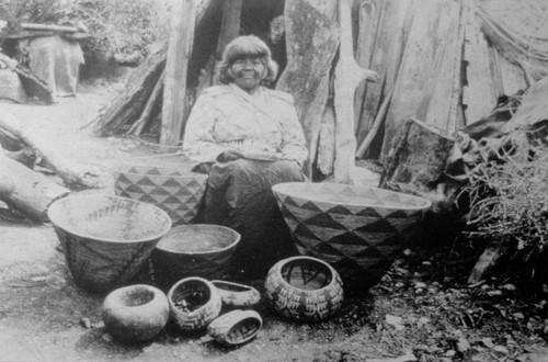 Pomo Indian woman with baskets