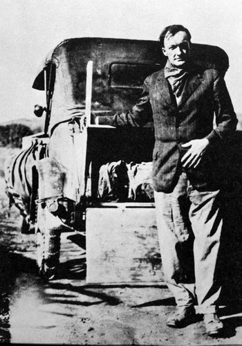 John Peabody Harrington leaning on car