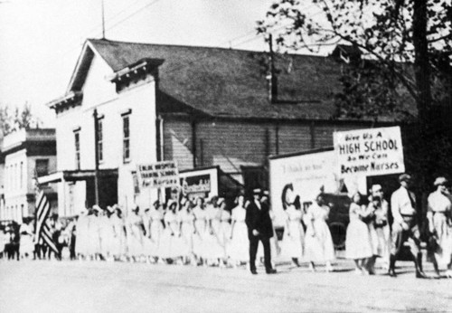 Dr. Enloe with group of young women in nurse's uniforms