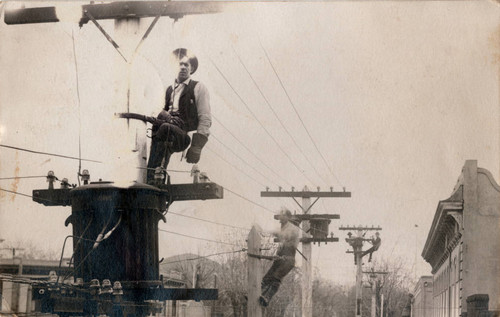 P G & E lineman on poles in Chico