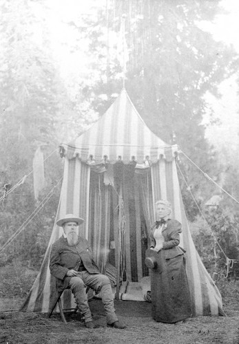 Annie and John Bidwell in front of their camping tent