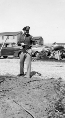 Lt. Higgens using a shovel — Calisphere