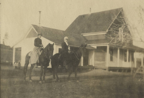 Two women on horseback by Coon Home