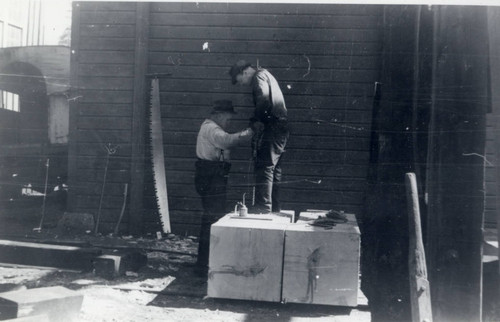 Men Drilling Lumber