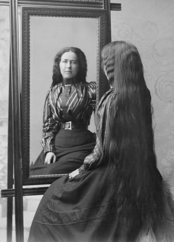 Portrait of a woman in front of mirror