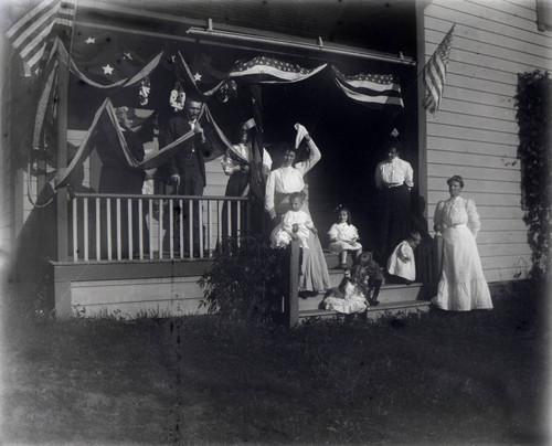 People on porch with flags in Quincy