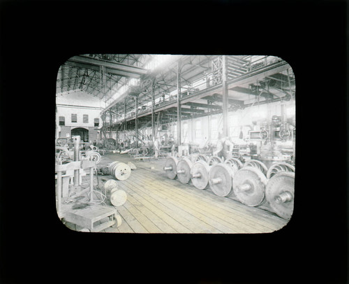 Machinery in warehouse, hand colored lantern slide