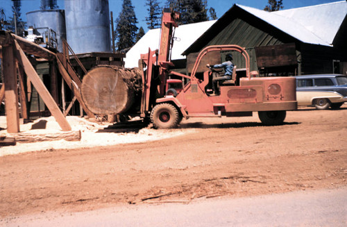 Placing a huge log in the splitter--Soper-Wheeler Company