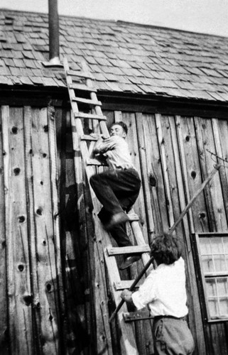 Glenn M. Way repairing the roof of the Josh house