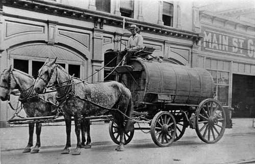 Sprinkling Wagon in Front of Firehouse