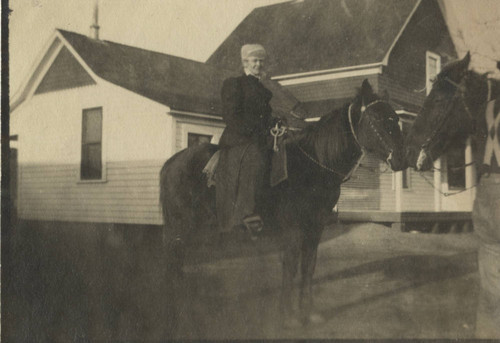 Woman on horseback by Coon Home