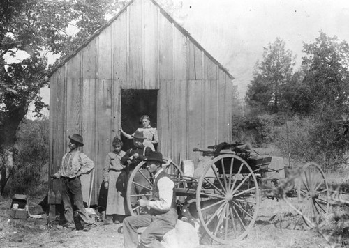 Group of people in front of a shed