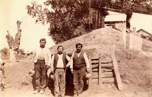 Three Rancheria Indians in front of a sweat lodge