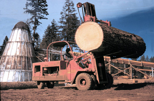 Forklift with log in front of teepee burner--Soper-Wheeler Company