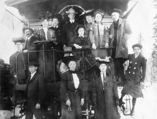 People posed on train car or locomotive