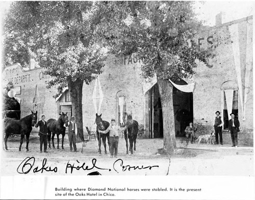 Men with horses in front of Fashion Stables building