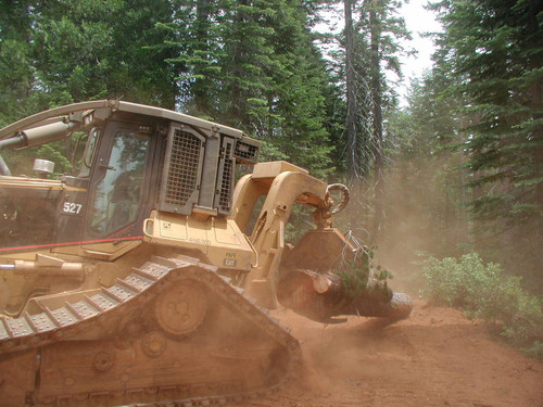 CAT skidder moving a log--Soper-Wheeler Company