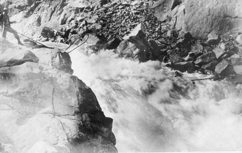 Railroad construction worker standing next to Feather River