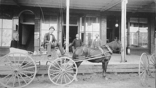 Horse and wagon in front of Fisher's Grocery Store