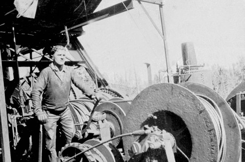 Unidentified crew member at Lyonsville posed with spools of cable