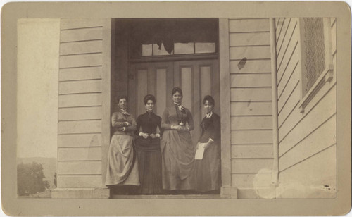 Four women standing in doorway