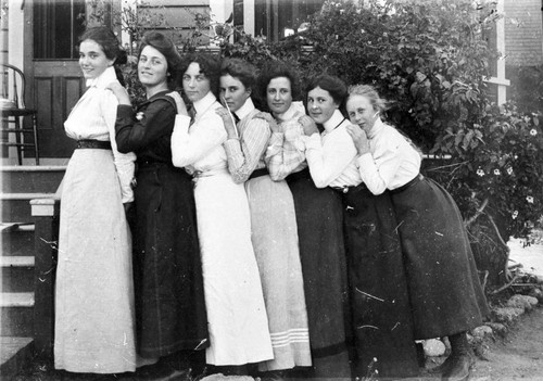 Group of firls in front of a house