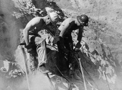 Drilling blast holes at Shasta Dam construction site