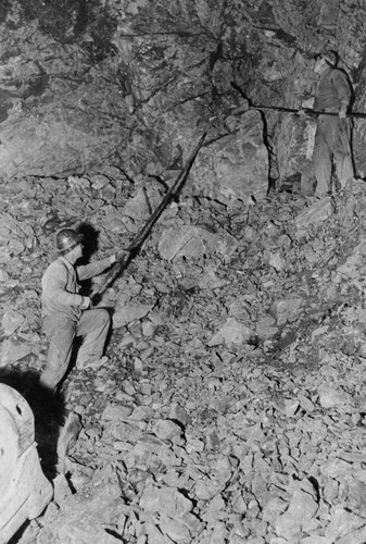 Barring down blasting material, Shasta Dam construction