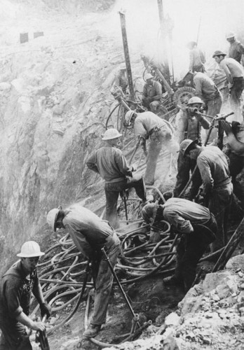 Blasting holes in the right abutment during the construction of Shasta Dam