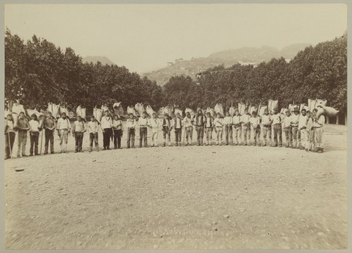 Untitled (Men carrying harvested crop)