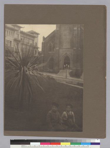 [children sitting on grass in Portsmouth Square]