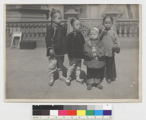 [four children on sidewalk]