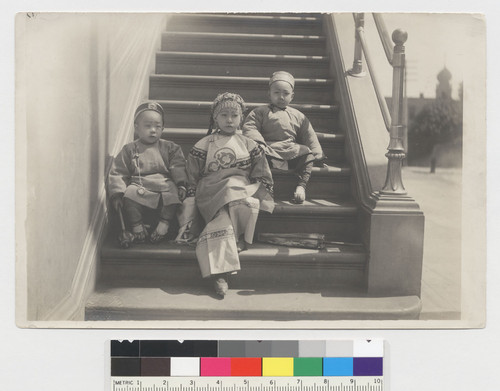 [three children on staircase]