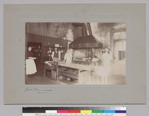 [Chinese cook in kitchen with three white men]