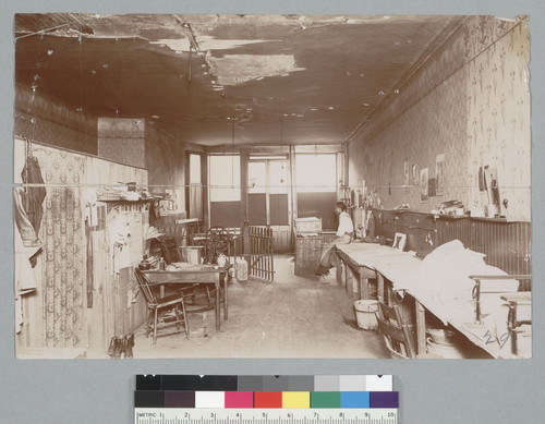 [Man seated inside laundry]