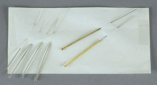 Acucpuncture needles; 2 gold; 2 steel; 2 silver; all in clear medicine bottles