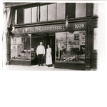 Otto and Frieda Hallerstede in front of their bakery and delicatessen on San Pablo Avenue between 19th and William Streets in Oakland, California