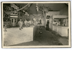 Butchers stand behind the counter at Central Market, corner of 10th and Clay Streets