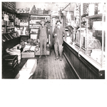 Two men pose inside Caesar Orio's grocery market at 5010 Telegraph Avenue near 51st Street in the Temescal district of Oakland, California