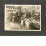 Unidentified produce merchant stands in his store in Oakland, California