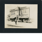 A man and woman stand in front of East Bay Market, 815 Washington Street