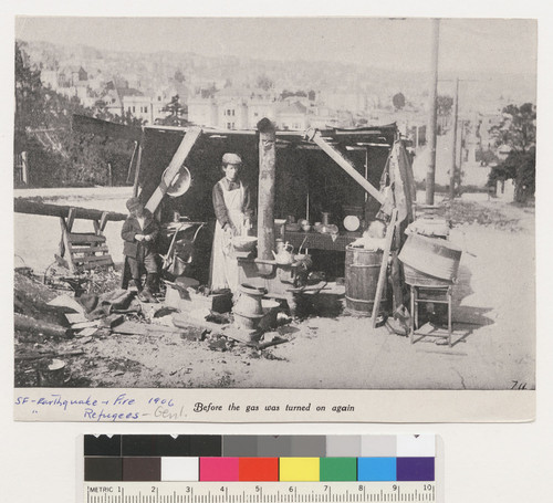 Before the gas was turned on again. [Woman and child in street kitchen. Clipping.]