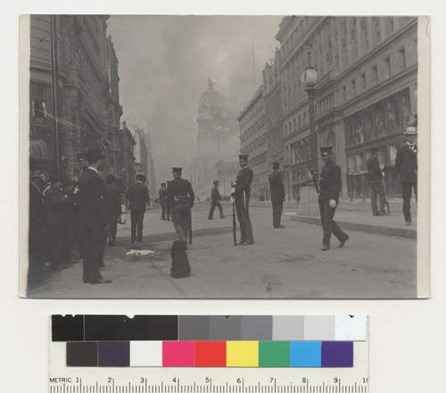 Market St., 800 block. [Police officers (?) in street. Call Building burning in distance.]