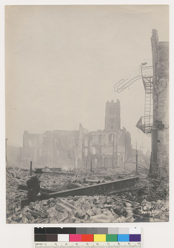 [Ruins and rubble along Dupont St. (now Grant Ave.). St. Mary's Church at California St., center. No. 54.]